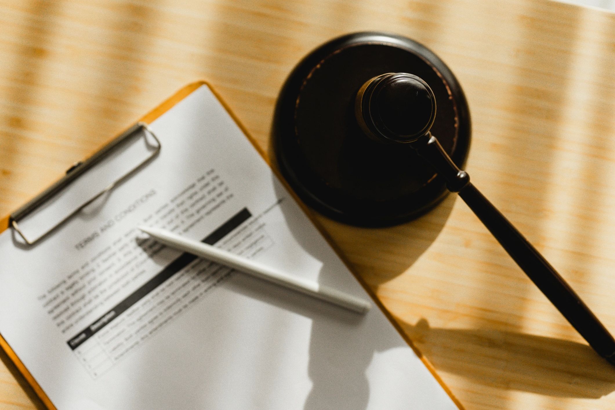 Judge Gavel and Employment Contract Document Representing Legal Agreement and Business Compliance